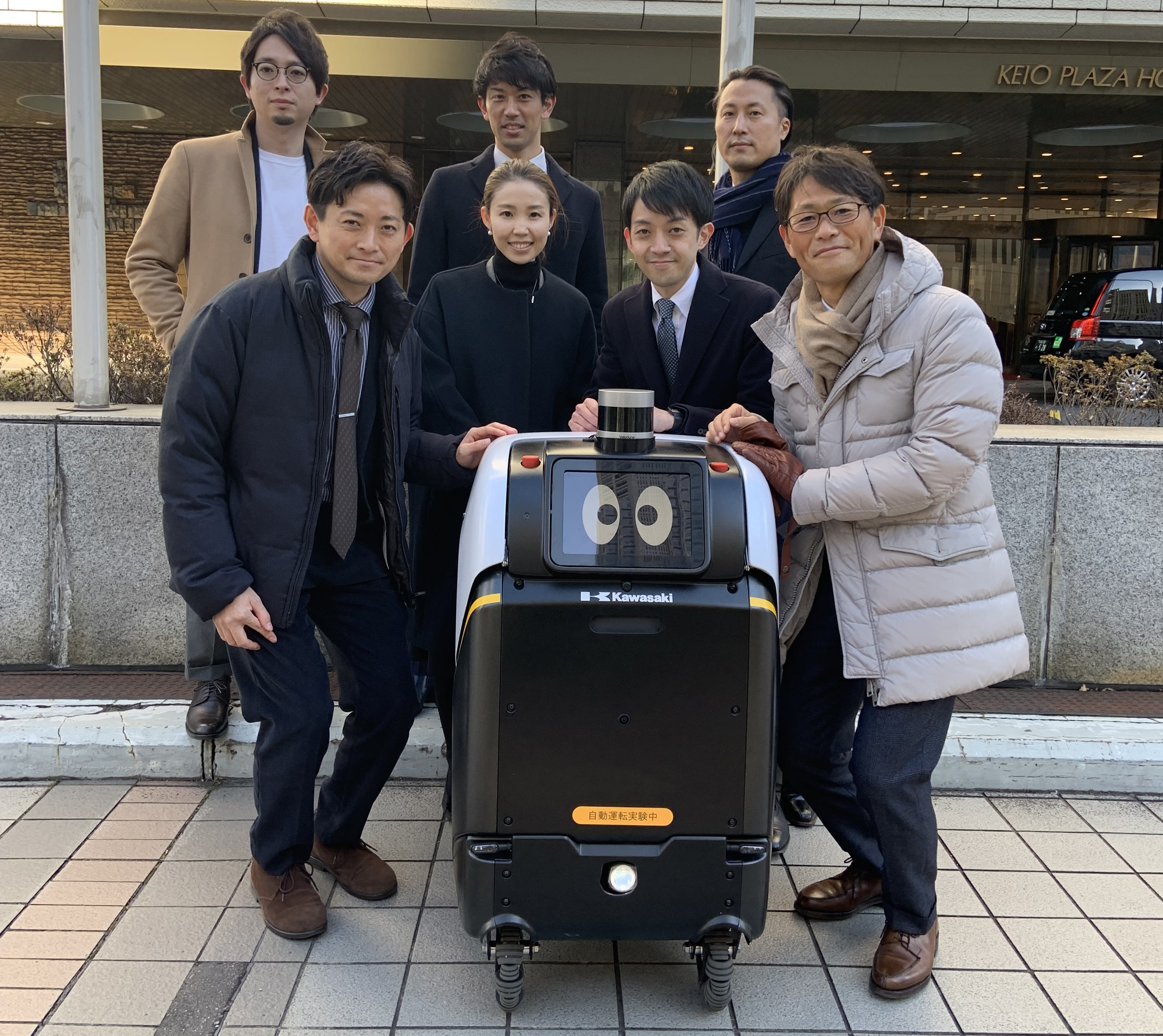 team posing with robot