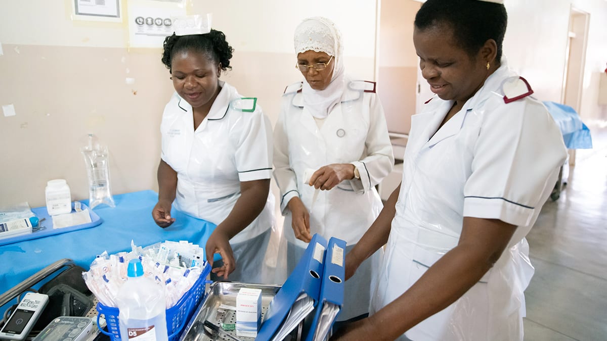 three nurses checking medical equipment