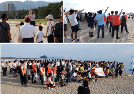 世界環境デーにビーチで活動を完了する人々のグループ