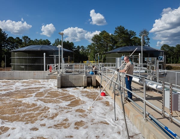 Person working at water recycling plant