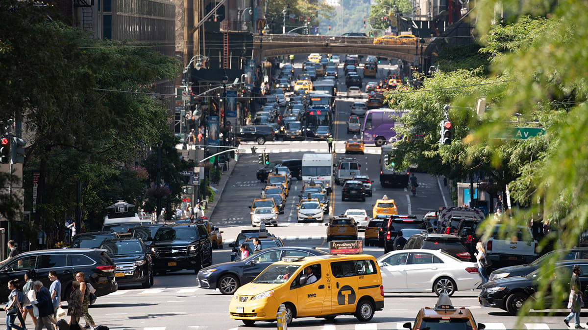 a taxi in the middle of a packed NYC street