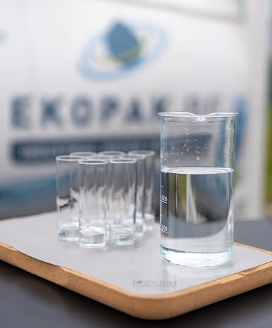 A beaker and seven test tubes on a table