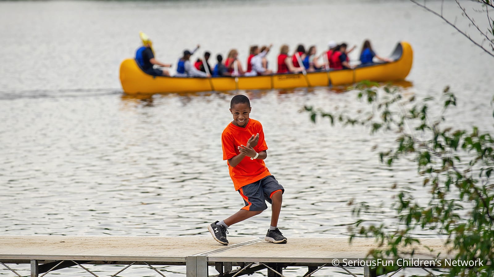 boy posing in front of lake