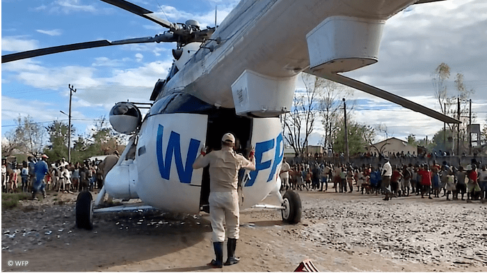 man opening the back of a helicopter